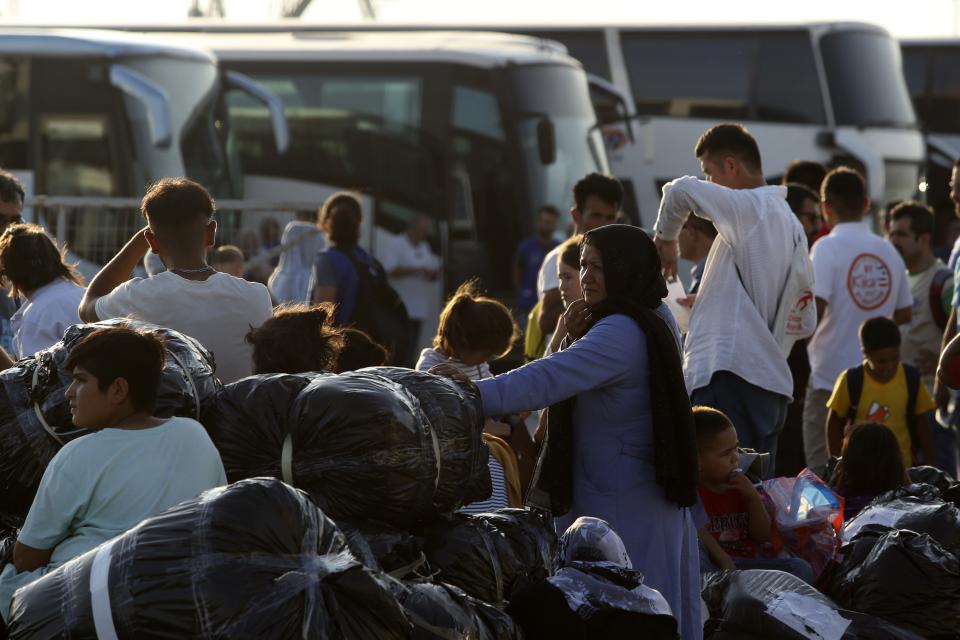 Refugees and migrants arrive at the port of Thessaloniki, northern Greece, Monday, Sept. 2, 2019. About 1,500 asylum-seekers were being transported from Greece's eastern Aegean island of Lesbos to the mainland Monday as part of government efforts to tackle massive overcrowding in refugee camps and a recent spike in the number of people arriving from the nearby Turkish coast. (AP Photo/Giannis Papanikos)