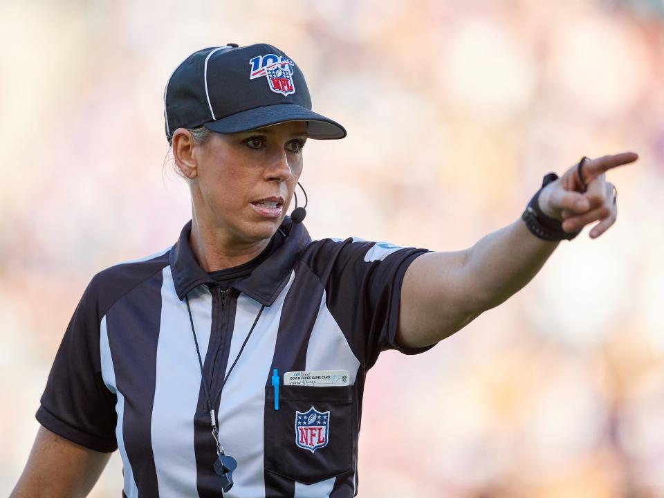 Sarah Thomas points down field during an NFL game in 2019.