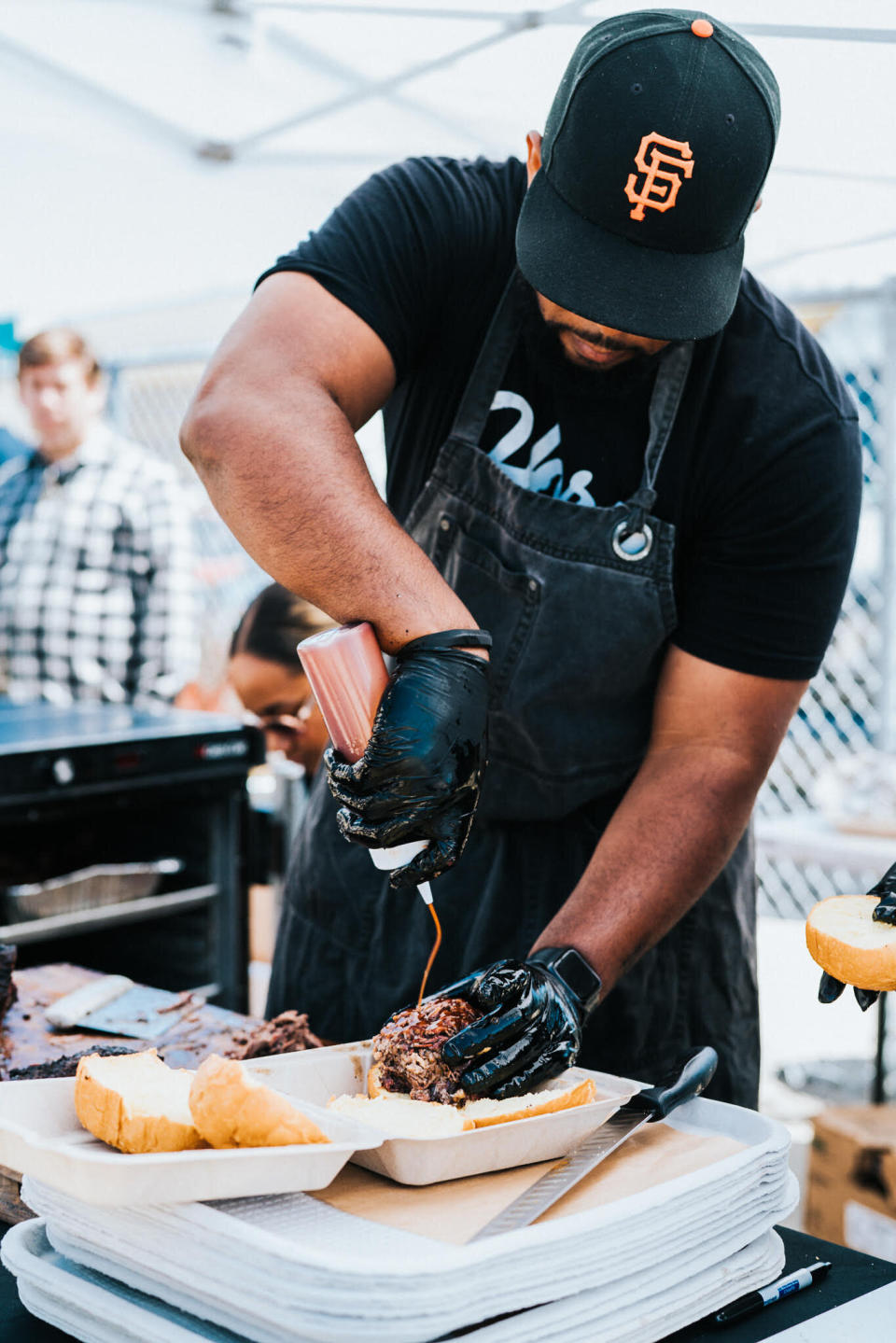 Matt Horn sauces the meat at Horn Barbecue in the Bay Area of Northern California. (Photo: Courtesy of Horn Barbecue)