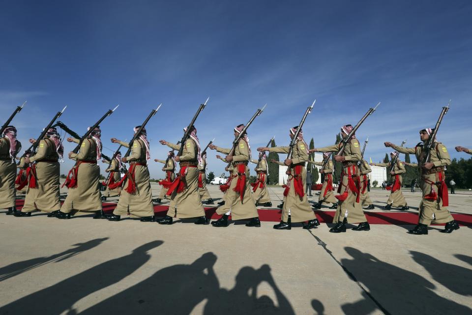 A Bedouin honour guard marches before bidding farewell to Pope Francis at Queen Alia International airport in Amman