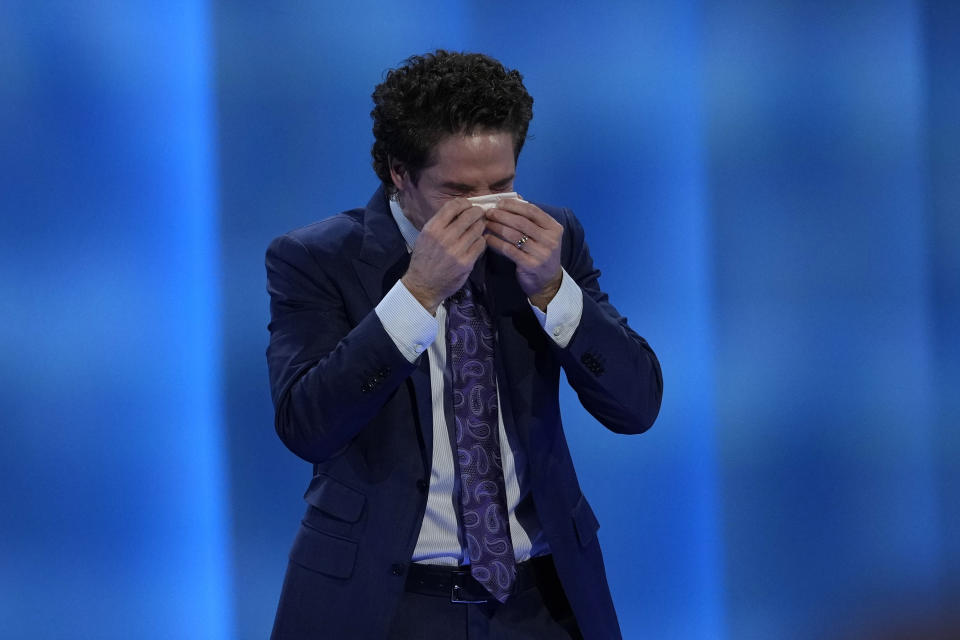 Pastor Joel Osteen wipes away tears as he talks about last week's shooting at Lakewood Church, Sunday, Feb. 18, 2024, in Houston. Osteen welcomed worshippers back to Lakewood Church for the first time since a woman with an AR-style opened fire in between services at his Texas megachurch last Sunday. (AP Photo/David J. Phillip)