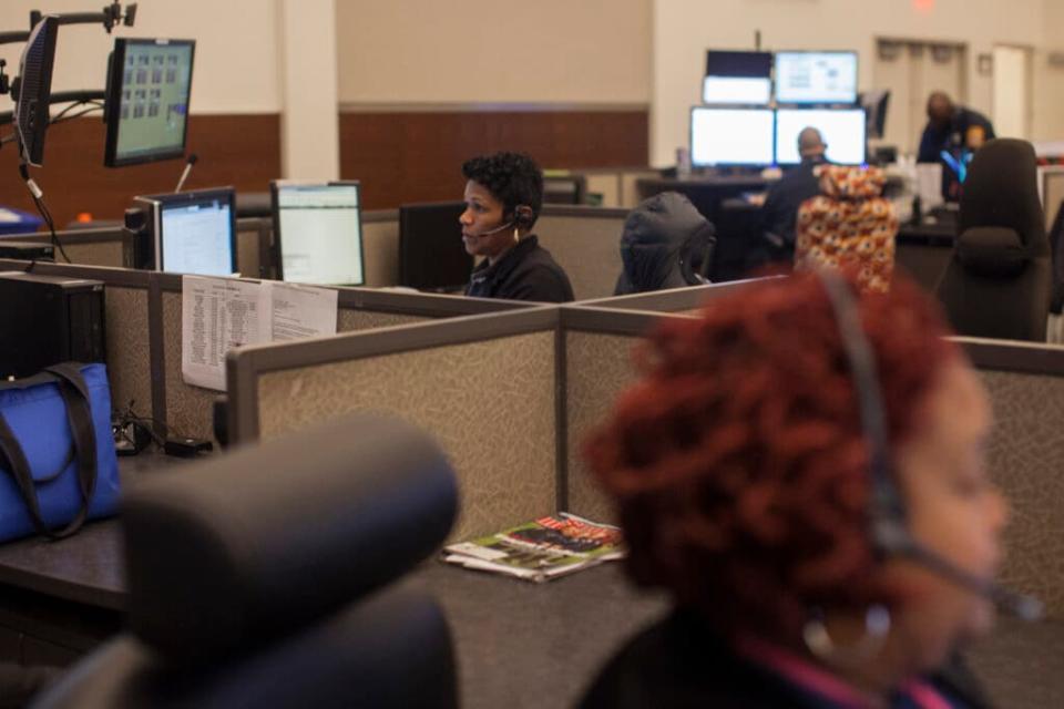 Office of Unified Communications dispatcher, Cynthia Little, center, answers calls in Southeast Washington, DC Tuesday November 26, 2013. Both 911 and 311 calls are answered at the Office of Unified Communications. (Photo by Jared Soares for The Washington Post via Getty Images)