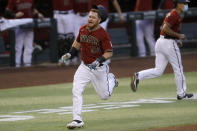 Arizona Diamondbacks' Kole Calhoun (56) rounds the bases after hitting an inside-the-park two-run home run during the fourth inning of a baseball game against the Houston Astros Wednesday, Aug. 5, 2020, in Phoenix. (AP Photo/Matt York)