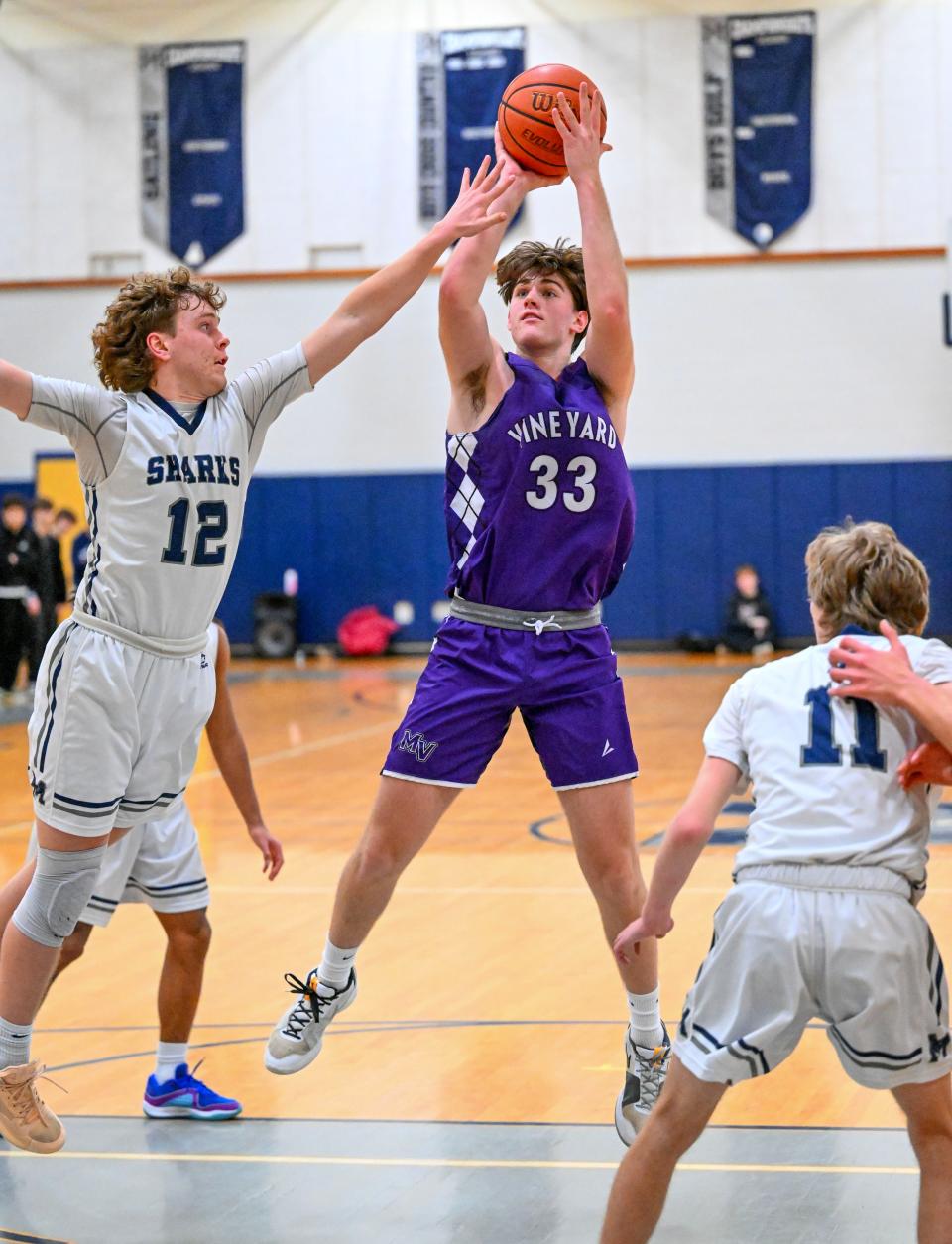 In this Jan. 26 photo, Josh Lake of Martha's Vineyard shoots over Finn Hyora of Monomoy.