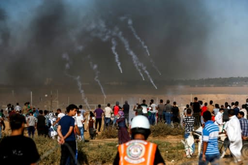 A picture taken on July 20, 2018 shows tear gas canisters fired by Israeli forces landing among protesters along the border with Israel east of Khan Yunis in the southern Gaza Strip