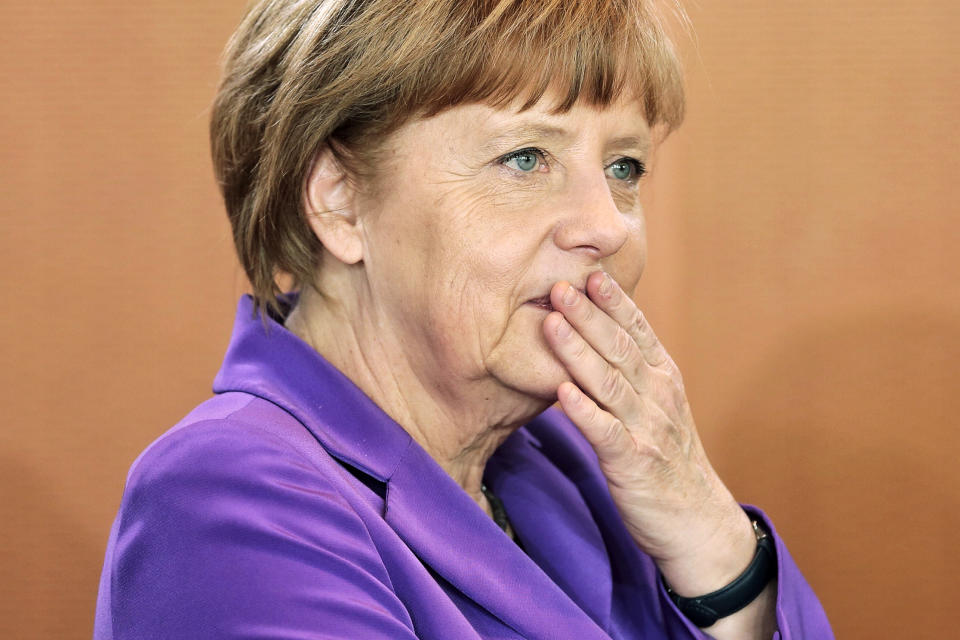 German Chancellor Angela Merkel pauses as she arrives for the weekly cabinet meeting at the chancellery in Berlin, Germany, Wednesday, April 2, 2014. (AP Photo/Markus Schreiber)