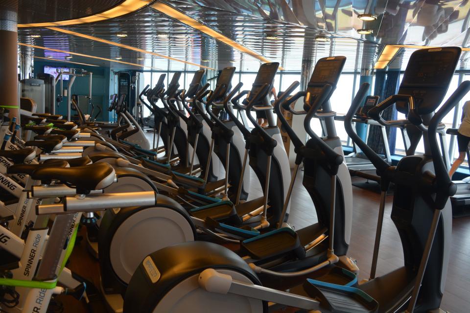 A row of exercise equipment on a cruise ship