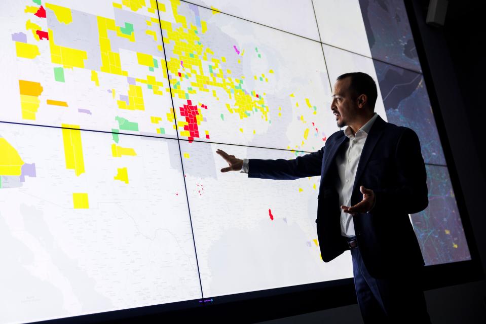 Anthony Lopez, senior researcher in the Geospatial Data Science Group within the Strategic Energy Analysis Center at the National Renewable Energy Laboratory in Golden, Colorado, looks at a map that visualizes the county and state ordinances regulating wind energy. Lopez curates the main U.S. government list of laws regarding renewable energy.