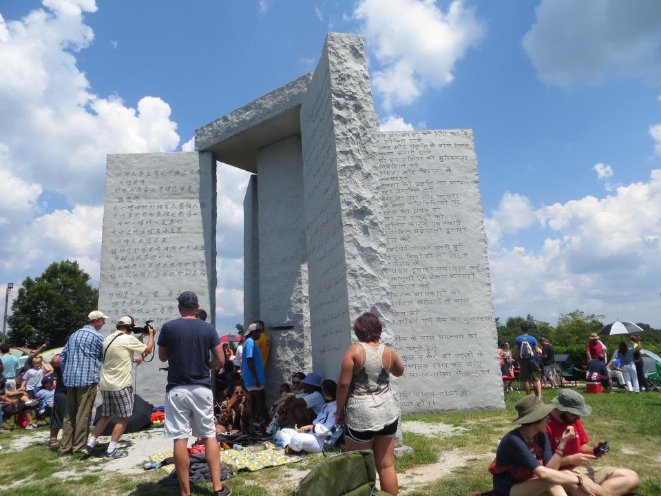 People gather at the Georgia Guidestones on Aug.  21, 2017, prior to a full eclipse of the sun.