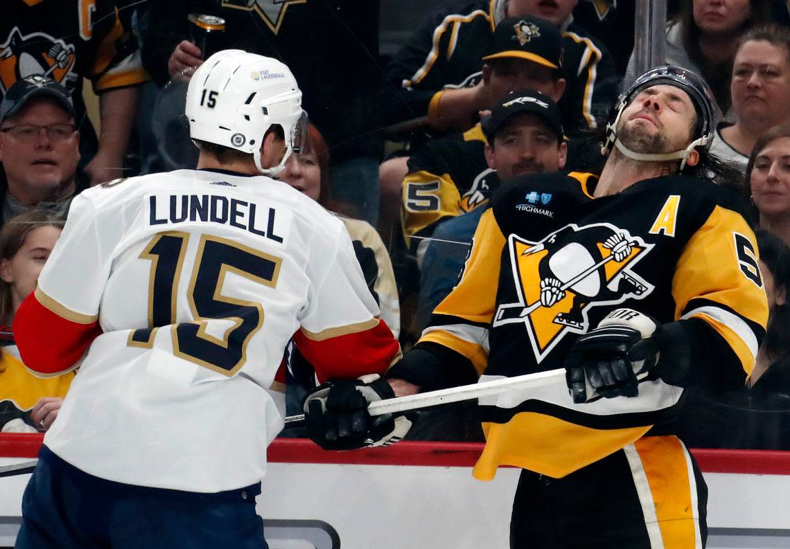 Jan 26, 2024; Pittsburgh, Pennsylvania, USA; Florida Panthers center Anton Lundell (15) hits Pittsburgh Penguins defenseman Kris Letang (58) during the second period at PPG Paints Arena. Mandatory Credit: Charles LeClaire-USA TODAY Sports