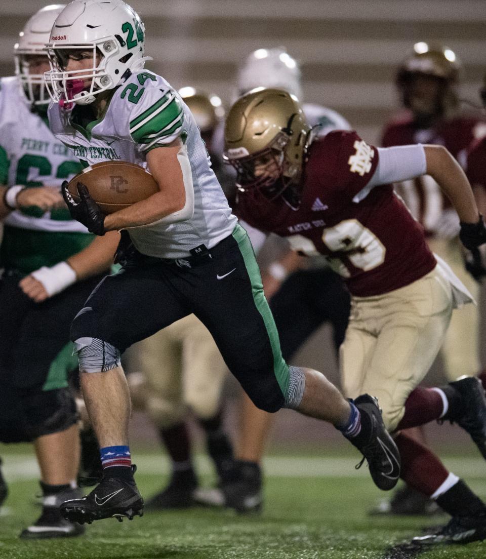 Perry Central’s Sawyer Guillaume (24) runs the ball as the Perry Central Commodores play the Mater Dei Wildcats at Central Stadium in Evansville, Ind., Friday evening, Oct. 21, 2022. 