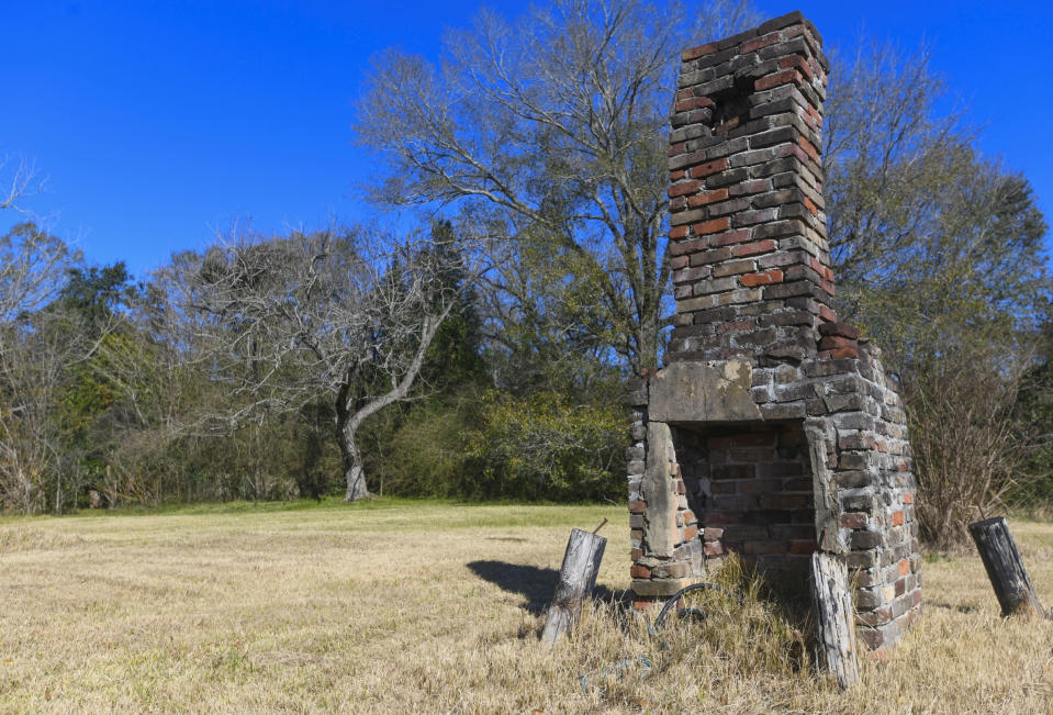 FILE - In this Tuesday, Jan. 29, 2019, file photo, a chimney, the last remaining original structure from the days when survivors of the Clotilda, the last known slave ship brought into the United States, inhabited the area, stands in an abandoned lot in Africatown in Mobile, Ala. On Wednesday, May 22, 2019, authorities said that researchers have located the wreck of Clotilda. (AP Photo/Julie Bennett, File)