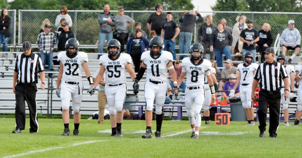 Waverly-South Shore players Kolby Ries (32), Wyatt Endres (55), Gavin Meadors (11) and Troy Kneeland (8) head to the center of the field for the pre-game coin toss prior to a high school football game earlier this season against Great Plains Lutheran.