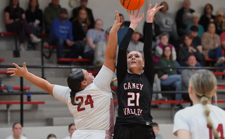 Dewey High School's Kyla Overton (24) defends against Caney Valley's Chloe Scherman (21) during basketball action in Dewey on Feb. 2, 2024.