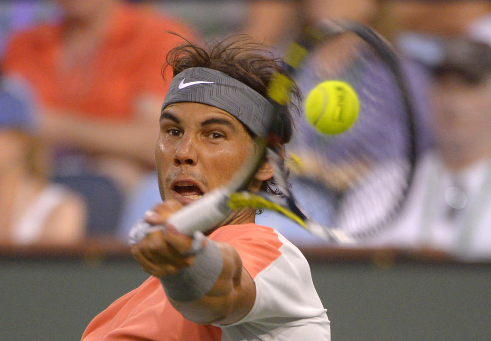 Rafael Nadal, of Spain, returns a shot to Alexandr Dolgopolov, of Ukraine, during their match at the BNP Paribas Open tennis tournament, Monday, March 10, 2014, in Indian Wells, Calif. Dolgopolov won 6-3, 3-6, 7-6 (5). (AP Photo/Mark J. Terrill)