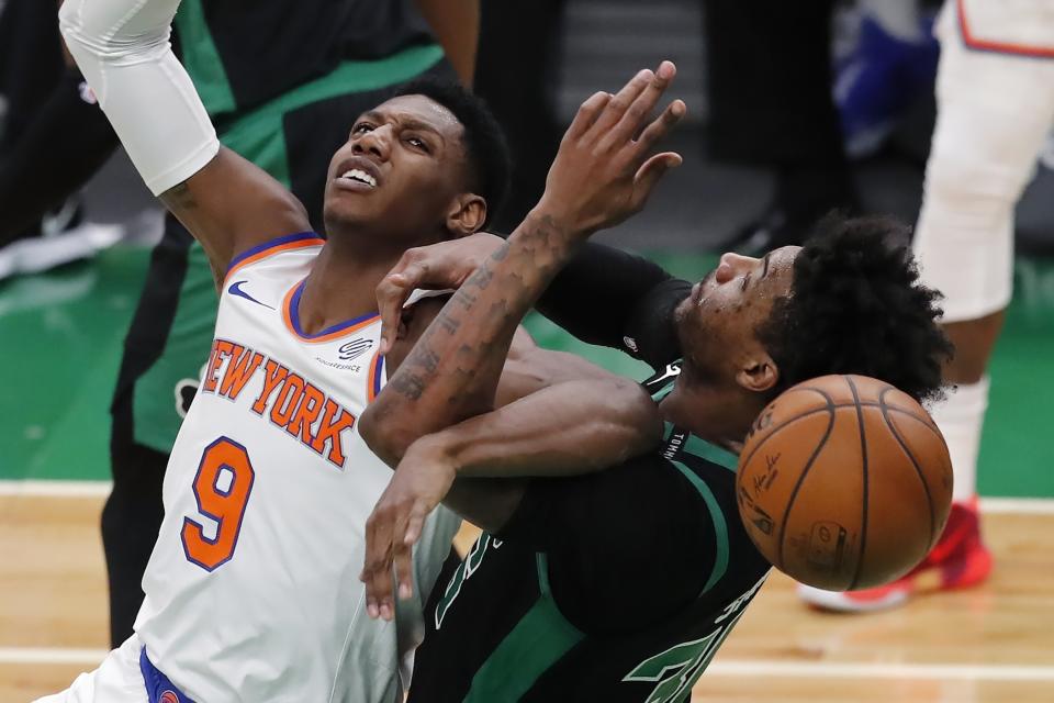 New York Knicks' RJ Barrett (9) and Boston Celtics' Marcus Smart (36) battle for the ball during the first half of an NBA basketball game, Sunday, Jan. 17, 2021, in Boston. (AP Photo/Michael Dwyer)