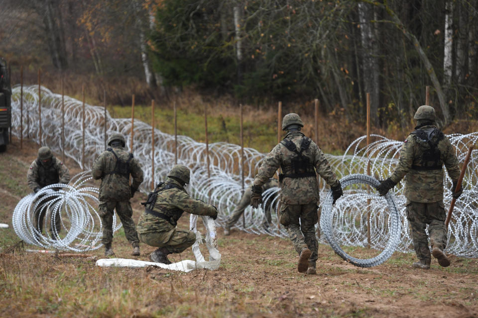 FILE - Polish soldiers begin laying a razor wire barrier along Poland's border with the Russian exclave of Kaliningrad in Wisztyniec, Poland, on Wednesday Nov. 2, 2022. At the beginning of November 2022, Polish soldiers began laying coils of razor wire on the border with Kaliningrad, a Russian region wedged between Poland and Lithuania. (AP Photo/Michal Kosc, File)