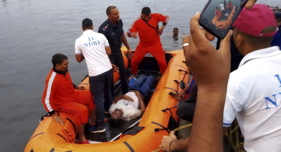 In this handout photo provided by the National Disaster Response Force, rescuers recover the body of a victim from a lake in Bhopal, in the central Indian state for Madhya Pradesh, Friday, Sept. 13, 2019. Police officer Akhil Patel said more than 10 Hindu worshippers drowned when their boat capsized during a religious celebration while they were immersing a big idol of Hindu god Ganesh into the lake. (National Disaster Response Force via AP)