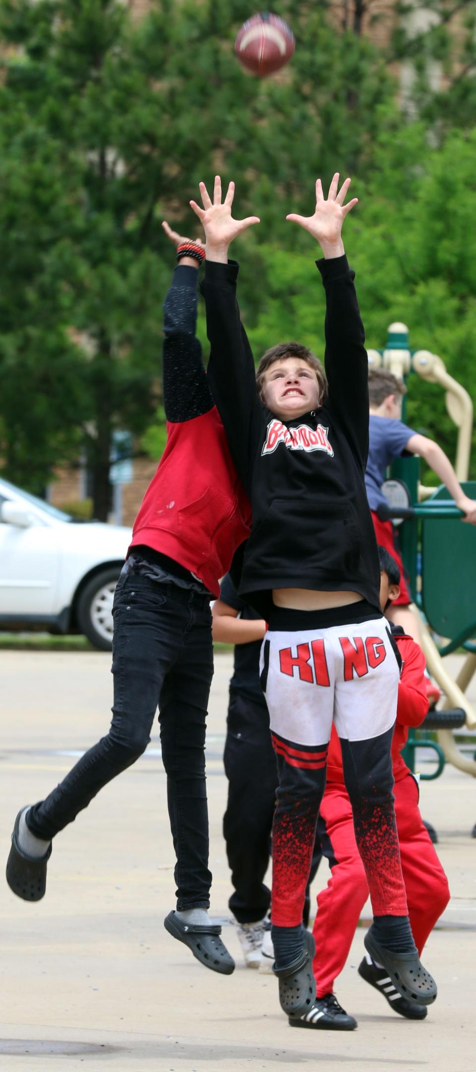 Twelve-year-old Dustin Johnson goes up for the catch as he and other students play catch with Shelby Police officers during a reading celebration held Friday, May 13, 2022, at Shelby Intermediate School on South Post Road.