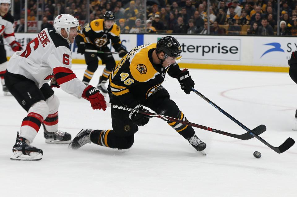 <p>
              New Jersey Devils defenseman Andy Greene (6) and Boston Bruins center David Krejci (46) reach for the puck during the second period of an NHL hockey game Thursday, Dec. 27, 2018, in Boston. (AP Photo/Elise Amendola)
            </p>