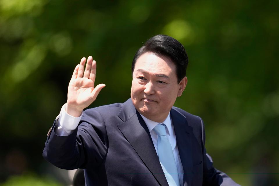 South Korea's new President Yoon Suk Yeol waves from a car after the Presidential Inauguration outside the National Assembly in Seoul, South Korea, Tuesday, May 10, 2022.