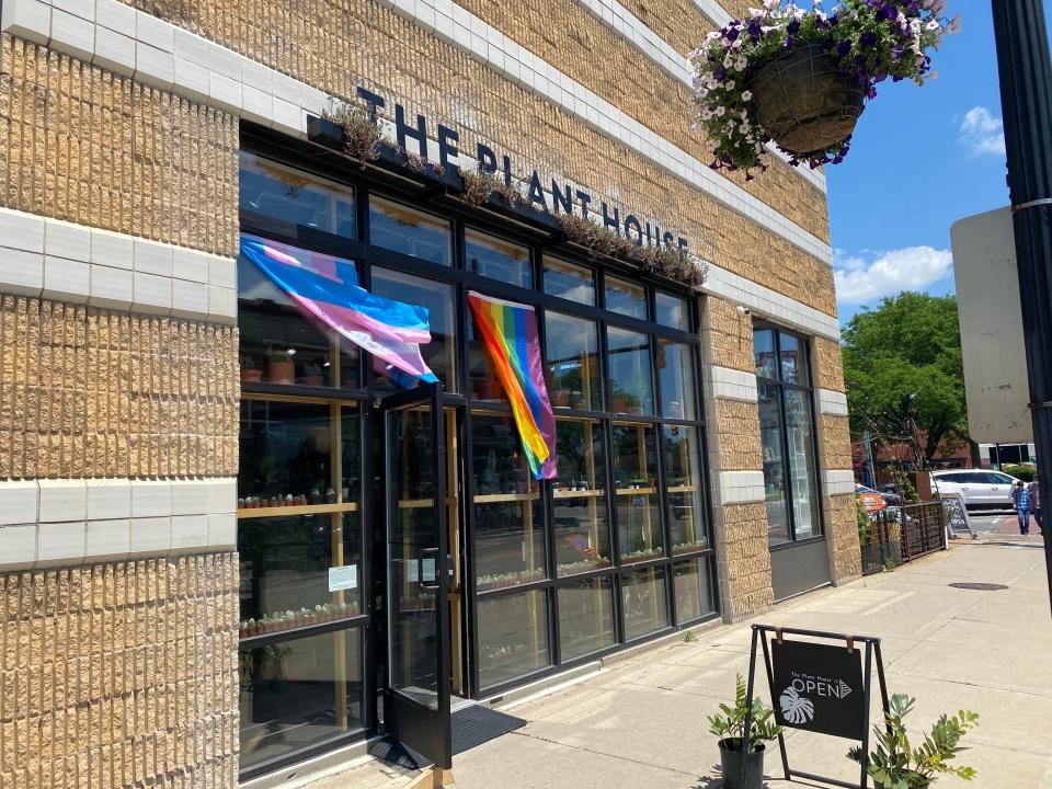 two pride flags hanging from a storefront in ferndale MI