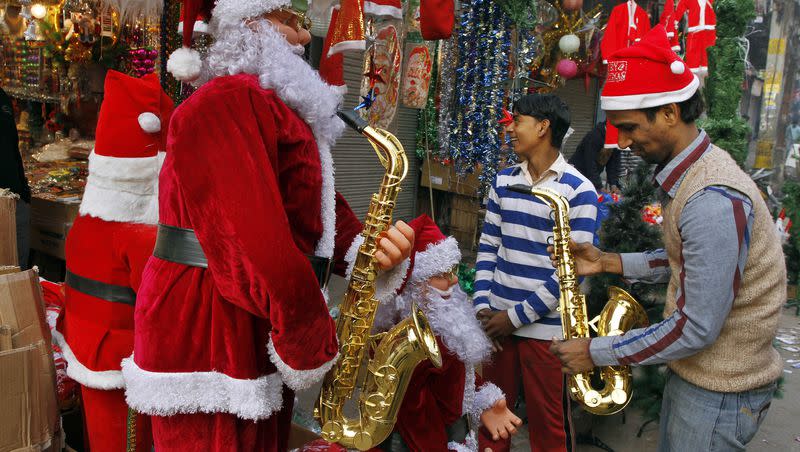 Indian salesmen decorate their shop to attract customers in New Delhi, India, on Saturday, Dec. 24, 2011. Christmas Day is observed as a national holiday in India.
