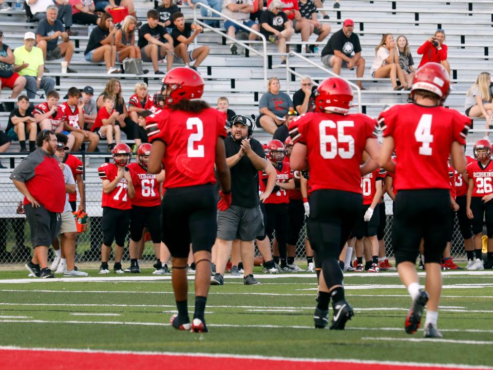 Coshocton coach Steve Smith encourages his defense after allowing a touchdown against visiting Malvern in an Ohio High School football scrimmage on Aug. 10, 2023, at Stewart Field.