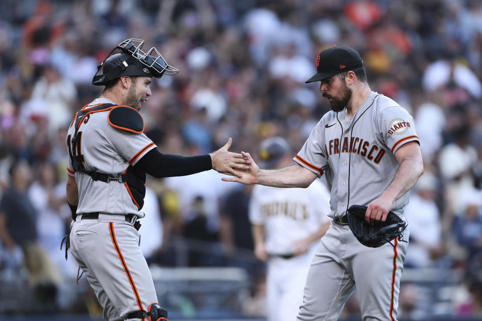 San Francisco Giants starting pitcher Carlos Rodon, right, celebrates with catcher Austin Wynns after they defeated the San Diego Padres in a baseball game Saturday, July 9, 2022, in San Diego. (AP Photo/Derrick Tuskan)