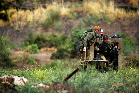 Israeli soldiers can be seen near the Israeli side of the border with Syria in the Israeli-occupied Golan Heights, Israel May 9, 2018. REUTERS/Amir Cohen