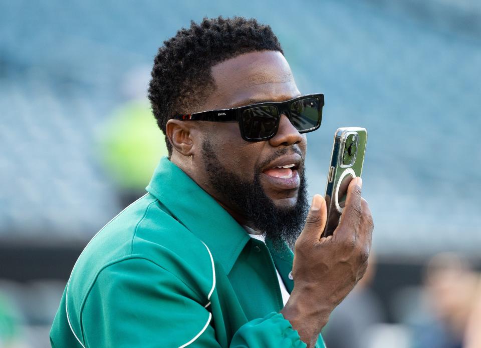 Week 2: Actor Kevin Hart talks on the phone during warmups before the Minnesota Vikings-Philadelphia Eagles game at Lincoln Financial Field.