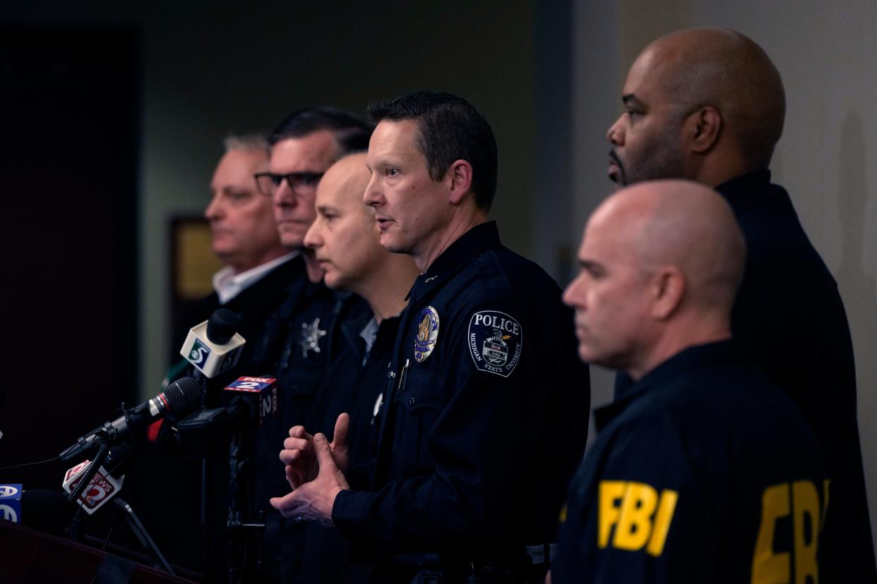 Michigan State University interim deputy police chief Chris Rozman, center, joins law enforcement officials while addressing the media, Tuesday, 14 February2023 (AP)