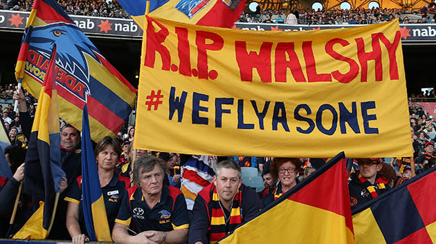 Fans fly banners in tribute to Walsh.