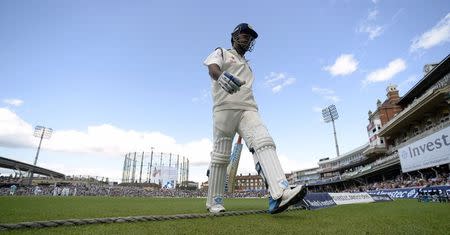 Mahendra Singh Dhoni leaves the field after being dismissed for a duck during the fifth test cricket match against England at the Oval cricket ground in London August 17, 2014. REUTERS/Philip Brown