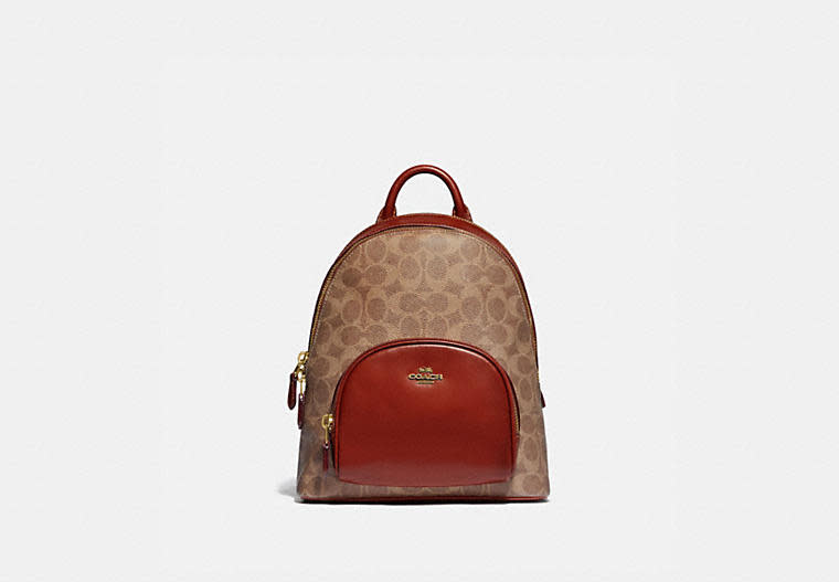 Carrie Backpack 23 In Signature Canvas. Image via Coach.