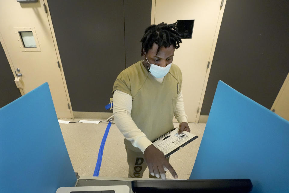 Tykarri Skillon, an inmate at the Cook County, Ill., jail votes in a local election at the jail's Division 11 Chapel on Saturday, Feb. 18, 2023, in Chicago. (AP Photo/Charles Rex Arbogast)