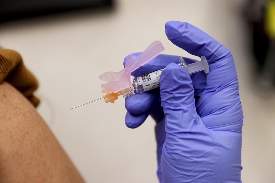 Nurse practitioner Susana Sanchez administers a flu vaccination to Loisy Barrera at a CVS pharmacy and MinuteClinic on September 10, 2021 in Miami.