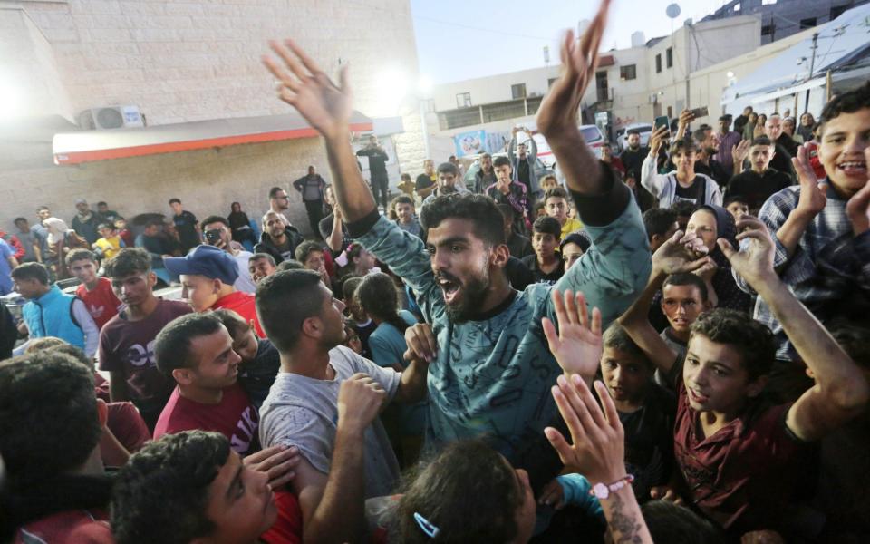Palestinians gather outside the Al-Aqsa Martyrs Hospital in Deir al-Balah