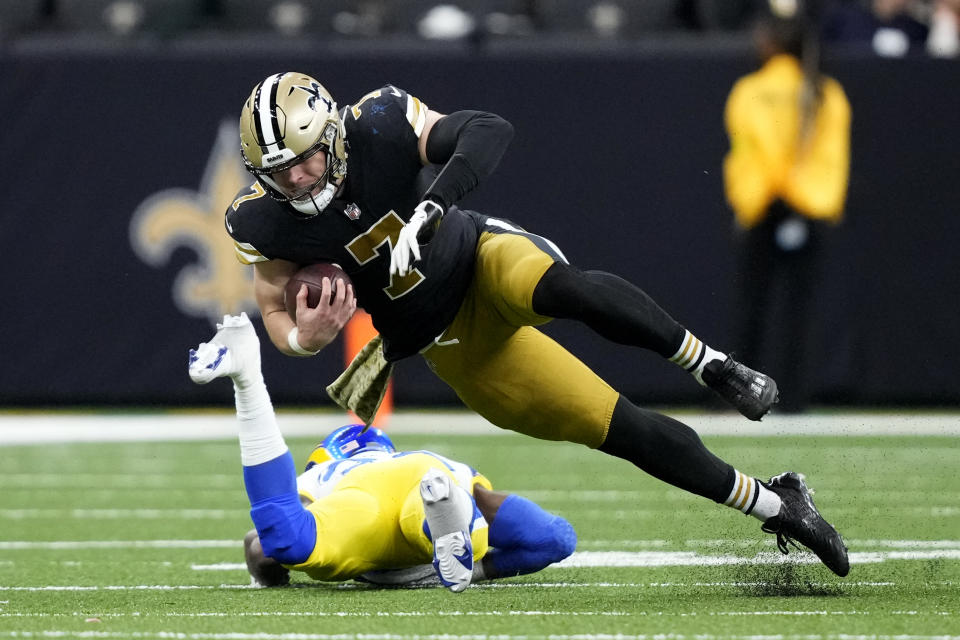 New Orleans Saints' Taysom Hill (7) is brought down by Los Angeles Rams safety Nick Scott in the second half of an NFL football game in New Orleans, Sunday, Nov. 20, 2022. (AP Photo/Gerald Herbert)