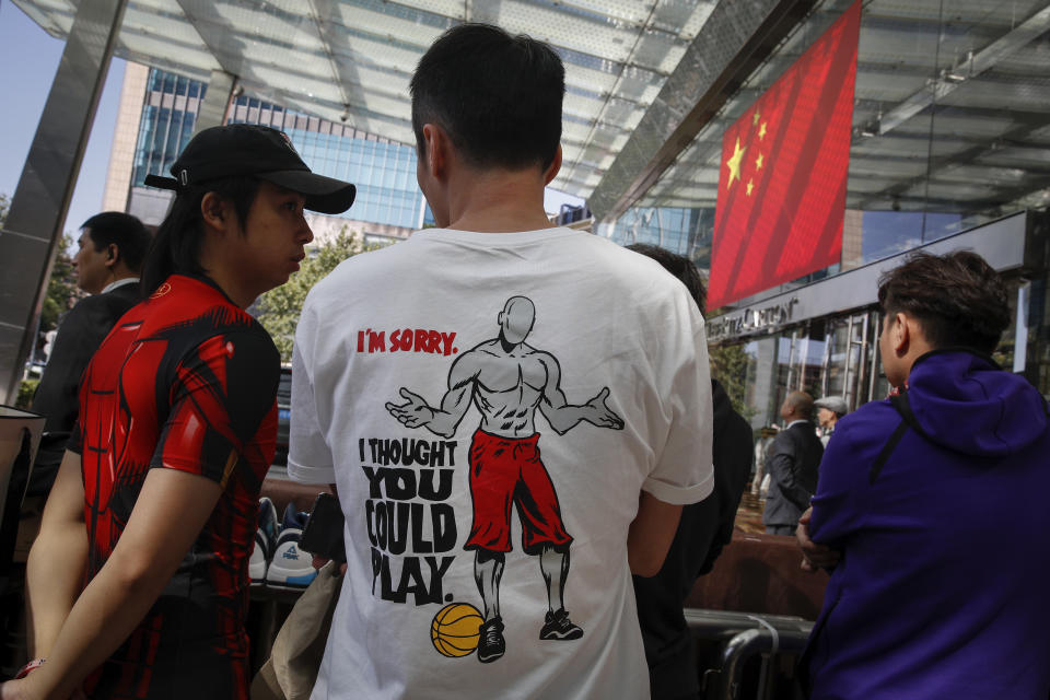 Chinese fans wearing dedicated t-shirt as they waiting for NBA players outside the Ritz-Carlton hotel in Shanghai, China, Thursday, Oct. 10, 2019. NBA Commissioner Adam Silver told the Brooklyn Nets and Los Angeles Lakers on Wednesday that the league is still expecting them to play as scheduled this week, even while the rift between the league and Chinese officials continued in ways that clearly suggested the two planned games in Shanghai and Shenzhen were anything but guaranteed. (AP Photo/Andy Wong)