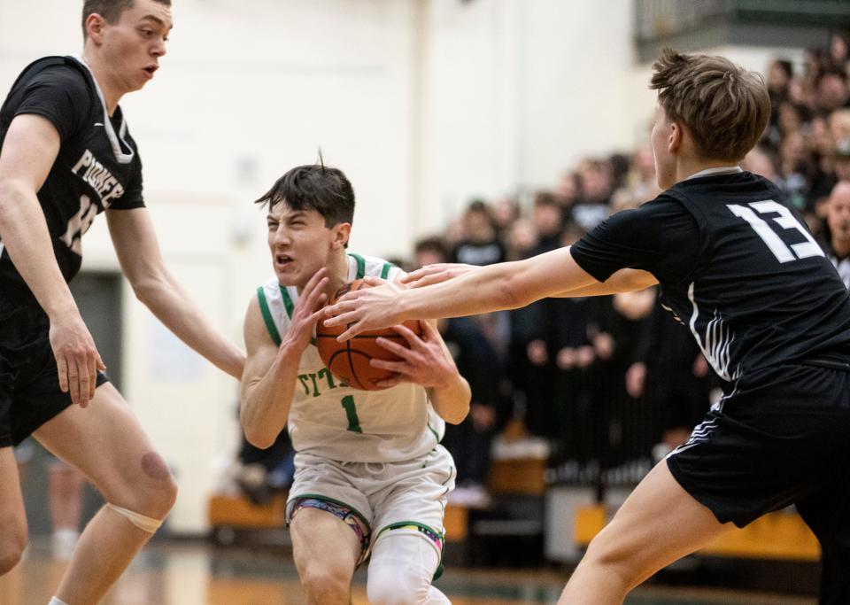 West Salem’s Jackson Leach (1) drives to the basket against Oregon City defenders during the first half at West Salem High School in Salem, Ore. on Wednesday, March 1, 2023.