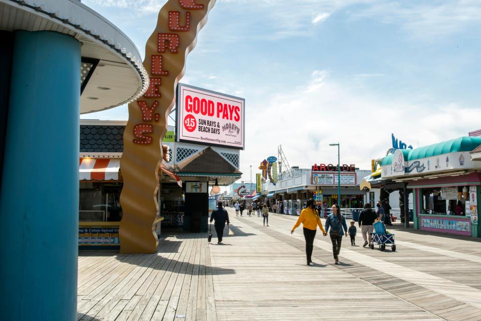 People walk down the Wildwood, N.J., boardwalk on May 7.