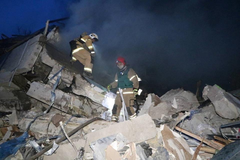 Rescuers work at a site of a residential building heavily damaged by a Russian missile strike (via REUTERS)