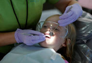 <p>Mallory Collins, 6, of Abington, Virginia, has her teeth cleaned at the Remote Area Medical Clinic in Wise, Va., July 21, 2017. (Photo: Joshua Roberts/Reuters) </p>