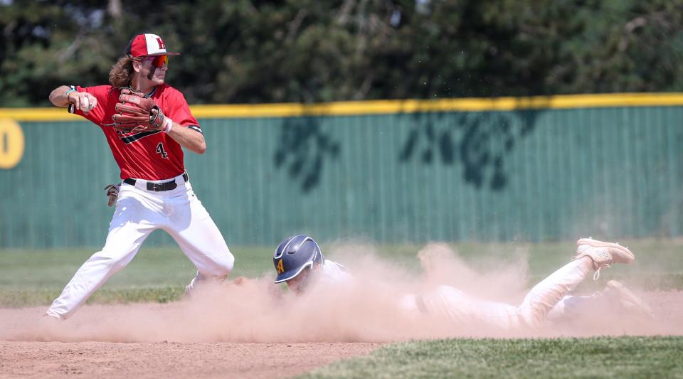 Ashton Warren of New Boston Huron forces out Airport's Tyler Lakatos beford throwing to first in the finals of the División 2 District at Airport Saturday. Huron won 4-1 in 10 innings.