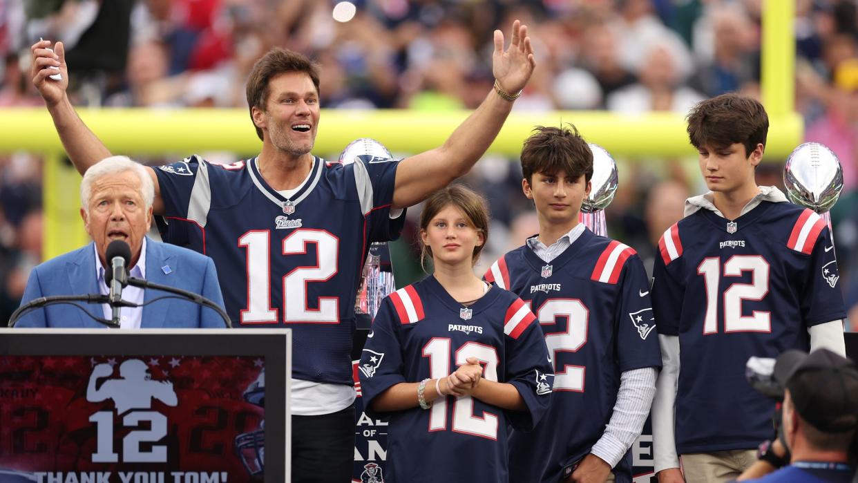 FOXBOROUGH, MASSACHUSETTS - SEPTEMBER 10: New England Patriots owner Robert Kraft speaks while former New England Patriots quarterback Tom Brady reacts while Brady's children, Vivian, Benjamin, and Jack, look on during a ceremony honoring Brady at halftime of New England's game against the Philadelphia Eagles at Gillette Stadium on September 10, 2023 in Foxborough, Massachusetts. (Photo by Maddie Meyer/Getty Images)