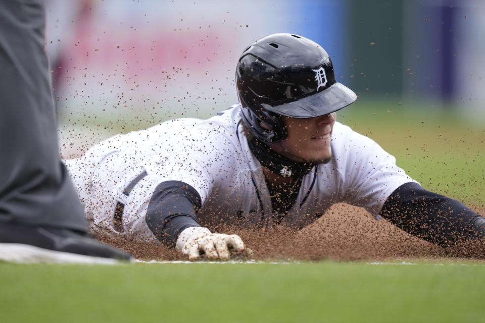 Detroit Tigers' Nick Maton safely slides into third from first on a single by Riley Greene during the first inning in the first game of a baseball doubleheader against the Cleveland Guardians, Tuesday, April 18, 2023, in Detroit. (AP Photo/Carlos Osorio)