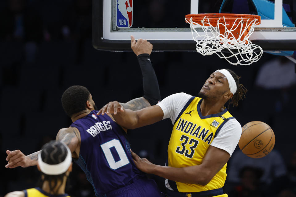 Charlotte Hornets forward Miles Bridges (0) dunks over Indiana Pacers center Myles Turner (33) during the second half of an NBA basketball game in Charlotte, N.C., Monday, Feb. 12, 2024. (AP Photo/Nell Redmond)