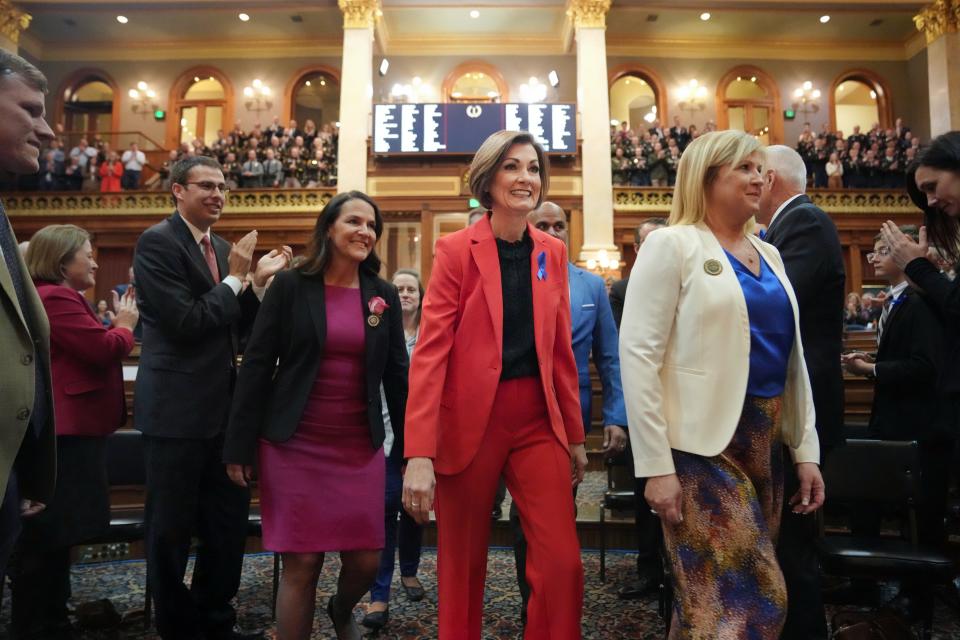 Gov. Kim Reynolds is escorted into the Iowa House of Representatives to give the annual Condition of the State address at the Iowa State Capitol, Tuesday, Jan. 9, 2024.