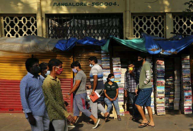 Indians wearing face masks in Bengaluru (Aijaz Rahi/AP)